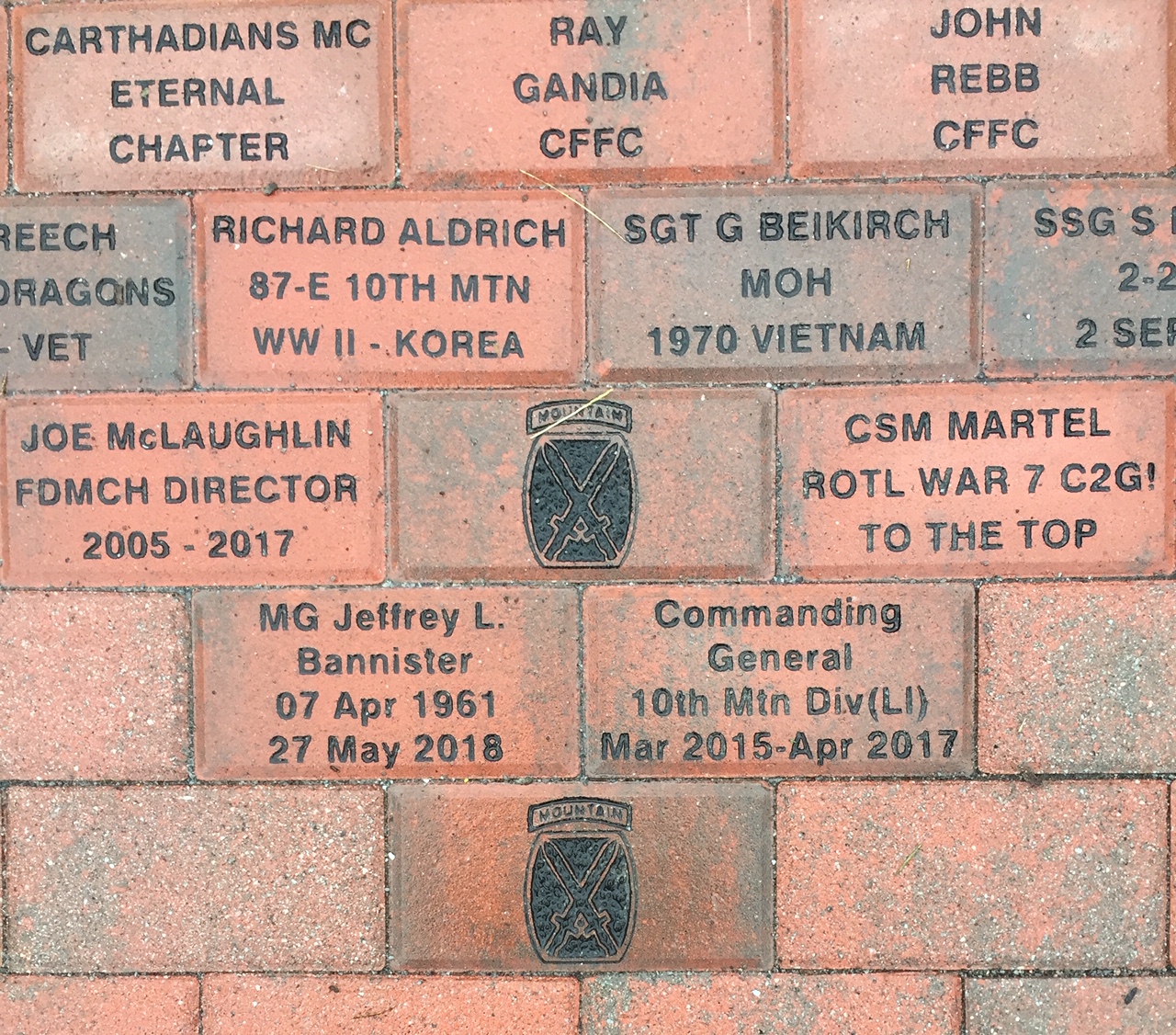 Close-up of an inscribed memorial brick at the 10th Mountain Division walkway.